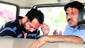 HS Deol (L) being taken away from his friends house in Chandigarh on Friday.