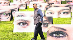 A man walks amidst 140 pictures with pairs of eyes in Berlin on Friday to draw the attention of the German Parliament to the plight of the worlds poor and symbolise the close attention people pay to the government's international development policies.  Reuter