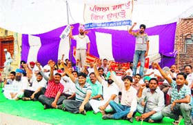Shopkeepers near Jallianwala Bagh protest against the government orders to vacate their shops to widen a road in Amritsar on Saturday