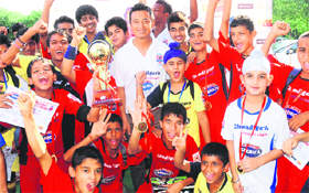 Baichung Bhutia along with budding soccer players at Sector 17 in Chandigarh on Saturday.
