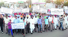 Residents take part in a march to extend support to Punjab IAS officer Kahan Singh Pannu in Mohali on Saturday.
