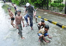 Children making merry after the rains in New Delhi on Saturday.