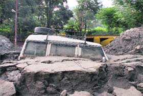 A jeep buried in mud on the main road near Srinagar in Garhwal on Saturday