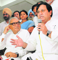 Newly appointed Congress general secretary Shakeel Ahmed, who is Punjab and Haryana affairs in charge, speaks as Chief Minister Bhupinder Singh Hooda looks on at Sector 28 in Chandigarh on Saturday. 