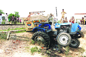 A tractor-trailer hit by a train on the Kaithal-Kurukshetra railway track in Kaithal on Friday.