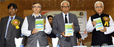 Governor NN Vohra (centre), flanked by Union Minister Salman Khurshid (right) and Chief Minister Omar Abdullah releases a book at an international conference at the University of Kashmir in Srinagar on Saturday. 