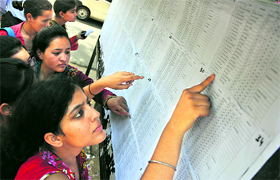 Students search for their names in the results of BA, BSc Part 1 at Government College for Women at Parade in Jammu on Saturday.