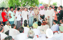 Former Punjab minister Santokh Singh Chaudhary and other Congress activists stage a dharna in front of the Apra police post in Phillaur on Saturday.