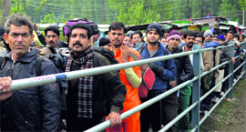 Amaranth yatris stand in a long queue at the Nunwan base camp.