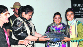 Governors wife Usha Vohra felicitates students at Raahat Ghar in Srinagar on Saturday.