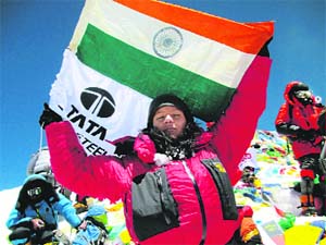 Top of the world: Arunima waves the National Flag at the summit of Mount Everest