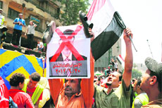 A protester holds a crossed-out picture of President Mohamed Mursi during a sit-in at Cairos Tahrir Square on Saturday. 