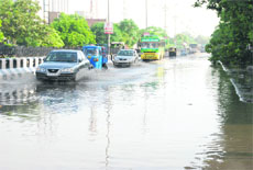 Vehicles pass through rainwater accumulated after downpour on the Bathinda-Goniana road on Sunday morning. 