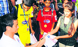 Indias soccer legend Baichung Bhutia gives autographs to budding football players at Sector 17 in Chandigarh