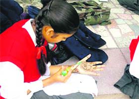 A student participates in the mehndi competition during the activity week in Hampton Court School in Mussoorie on Sunday