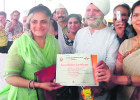 A blood donor being honoured at a blood donation camp organised by Nirankaris in Dehradun on Sunday