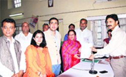 newly elected MP Pratibha Singh receives a certificate from District Election Officer Devesh Kumar after her victory in the Mandi bypoll on Sunday.