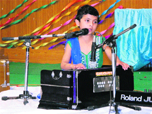 Tajeswani, a child artiste, sings a bhajan at the same function. 