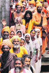 Sadhus stand in a queue to register for the Amarnath pilgrimage in Jammu on Sunday. More than 11,000 pilgrims left for the Amarnath cave shrine from the Nunwan and Baltal base camps on the third day of the yatra on Sunday.
