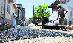 A road being carpeted at Lakshmi Nagar area in Jammu on Sunday
