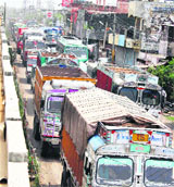 Vehicles move at a snails pace on the GT road due to the alleged faulty alignment of the road under construction adjacent to an overbridge in Chuggitti village in Jalandhar.
