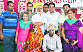 An underprivileged girl with her husband and well-wishers after her wedding at Pindi Dyal Dharamshala in Ludhiana.