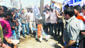 An effigy of Akali MLA Ranjit Singh Dhillon being burnt in Ludhiana on Sunday.