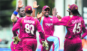 West Indies celebrate after restricting India to 229/7 in the second match of the Tri-Nation ODI series in Kingston on Sunday. India, however, struck back with three quick wickets to put the game back on even keel.