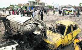 The site of a car bombing on the outskirts of Peshawar on Sunday.