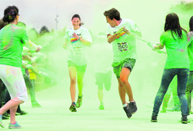 Participants of Color Run react as they get a coloured powder shower, based on corn flour, in Munich on Sunday.