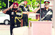 Lieutenant General NS Ghei, GOC, Chetak Corps, pays tributes at the Yodha Yaadgar during the Raising Day celebrations at the military station in Bathinda on Monday; Army jawans pay tribute to martyrs; and Army wives shield themselves from the scorching sun at the function