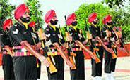 Lieutenant General NS Ghei, GOC, Chetak Corps, pays tributes at the Yodha Yaadgar during the Raising Day celebrations at the military station in Bathinda on Monday; Army jawans pay tribute to martyrs; and Army wives shield themselves from the scorching sun at the function