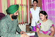 Gynaecologists Lieutenant Colonel Dr Manjit Singh Sidhu (retd) and Dr Arvind Sharma (below) examine patients at their clinics in Bathinda