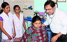 Gynaecologists Lieutenant Colonel Dr Manjit Singh Sidhu (retd) and Dr Arvind Sharma (below) examine patients at their clinics in Bathinda