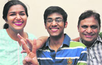 Arnav Aggarwal, who scored the first rank in the AIIMS exam, shares his success with his parents at their residence in Sector 37, Chandigarh, on Monday. Tribune photo: Parvesh Chauhan