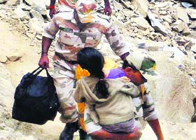 ITBP men rescue a child in flood-hit Gobind Ghat on Monday