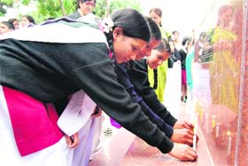 Students of Sanatan Dharm Inter College, Mussoorie, light candles in memory of the disaster victims in the state on Monday