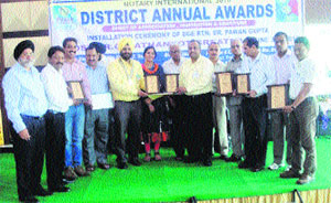 Members of the Rotary Club with the Rotary district governor after receiving an award at Pathankot on Sunday.
