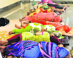  Pilgrims take a nap at the base camp for Amarnath yatris in Jammu on Monday. Tribune photo: Anand Sharma 