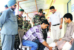Army authorities distribute artificial limbs at a camp in Rajouri on Monday. A Tribune photo