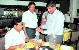 Health Department officials collect food samples from a restaurant in Urban Estate on Monday.