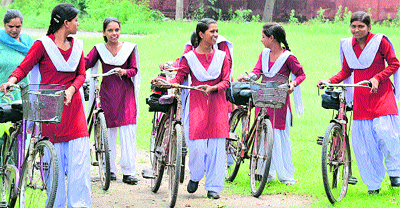Students going to school with their bicycles in Jalandhar on Monday.