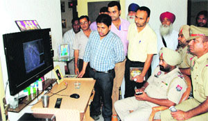 Missing girls kin and policemen look at the CCTV footage from where the girl went missing at Jodhewal Basti in Ludhiana