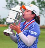 Inbee Park of South Korea kisses the trophy after her four-stroke victory at the US Womens Open on Sunday.