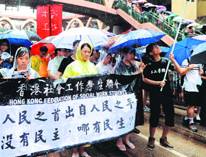 Protesters march during a pro-democracy rally and demand right to vote in Hong Kong on Monday, marking the 16th anniversary of the establishment of the Hong Kong Special Administrative Region.
