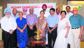 Arvinder Bedi (with medal, centre) and Prof Yogesh Chawla (fifth from left), Director, PGI, with members of the new team of Rotary Chandigarh Shivalik at a ceremony in Chandigarh on Tuesday.
