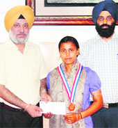 Trisha being honoured by the Principal of Khalsa College, 