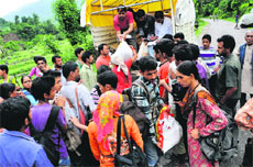 A voluntary group distributes relief material among people at Madkot in Dharchula tehsil of Pithoragarh on Tuesday.