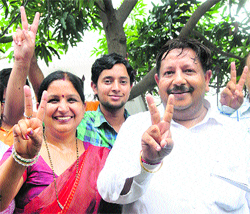 Renu Bala and her husband Brij Gupta flash the victory sign after her election as the Mayor in Karnal on Tuesday.