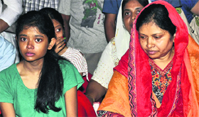 Grieving family members of Pakur SP Amarjit Balihar (inset) at his Ranchi residence on Tuesday.